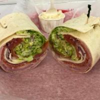 #29. Italian Wrap · Ham, salami, pepperoni, provolone cheese, lettuce, tomato, onions, oil a and vinegar in a fl...