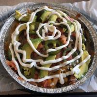 Super Nachos · Topped with spicy beef, cheddar and Jack cheese, jalapenos, salsa, avocado and sour cream.