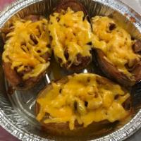 Loaded Potato Skins · Topped with cheddar cheese, crumbled bacon and a side of sour cream.