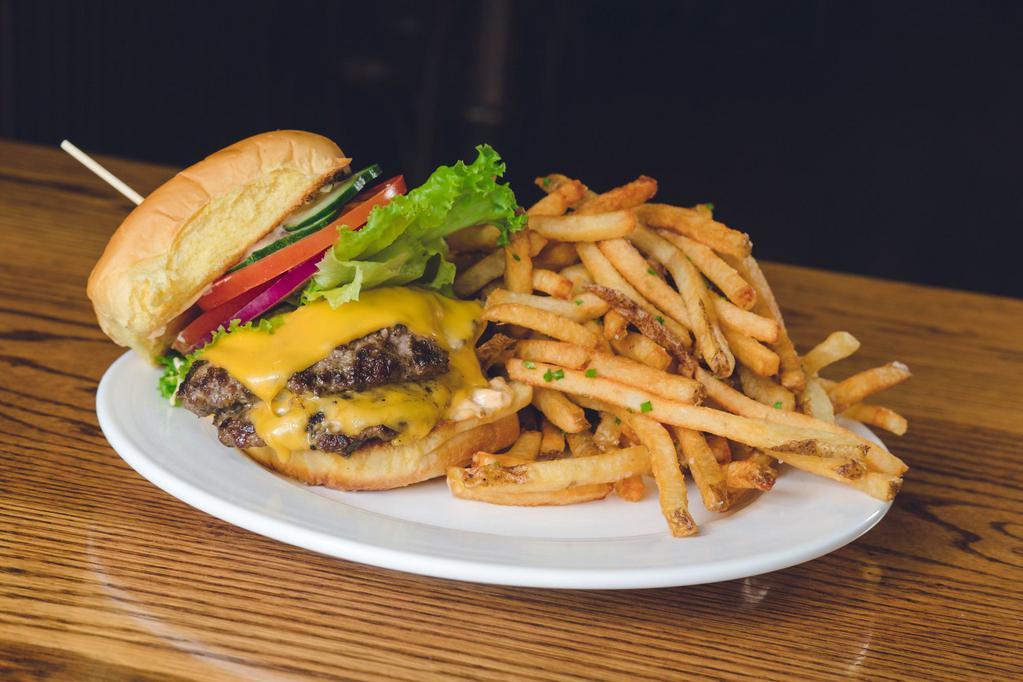Golden Years Burger · All beef patty, American cheese, aioli, lettuce, tomato, onion and pickles. Served on a brioche bun with a side of fries.