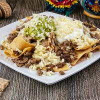 Super Carne Asada Nachos · Carne asada, beans, cheese, guacamole & sour cream.