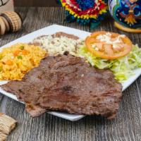 Carne Asada Plate · Carne asada, beans, rice, guacamole, lettuce and tomato. Served with either corn or flour to...