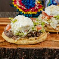 Sope Carne Asada · Beans, meat, lettuce, tomato, sour cream and Parmesan cheese.