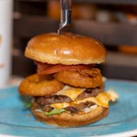 American Beef Burger · Flame grilled beef patty served in a large Brioche bun with (Onion rings, gherkin, American ...