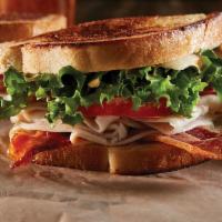 Classic Club Sandwich · Sourdough, roasted turkey, pepper jack cheese, applewood bacon, lettuce, tomato and Kilt Bur...