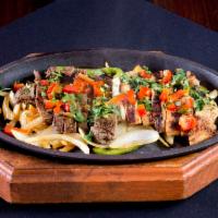 Fajita Tacos · Choice of fajita beef or chicken, grilled onions and peppers with a side of queso, Mexican r...