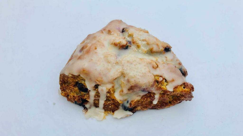 Lemon Blueberry Scone · Our lemon blueberry scone is uniquely crisp and buttery with crumbly corners and a soft, flaky interior, studded with organic blueberries, and a zest of Meyer lemon and topped with a drizzle of vanilla glaze.