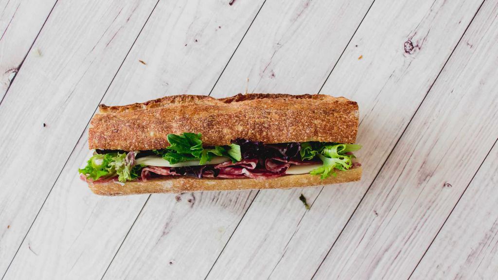 Salami and Provolone Ficelle · Sopressata and provolone cheese on a buttered ficelle baguette with organic baby greens.