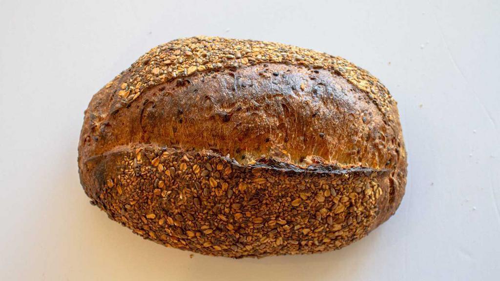 Flax Sunflower Seed Loaf · European style sourdough. Very tender open crumb, baked dark, 100% organic and naturally fermented with toasted flax and sunflower seeds throughout, topped with sesame seeds, flax seeds sunflower seeds, and oats.
