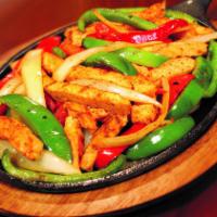 Chicken Fajitas · Marinated strips of chicken with grilled peppers and onions.