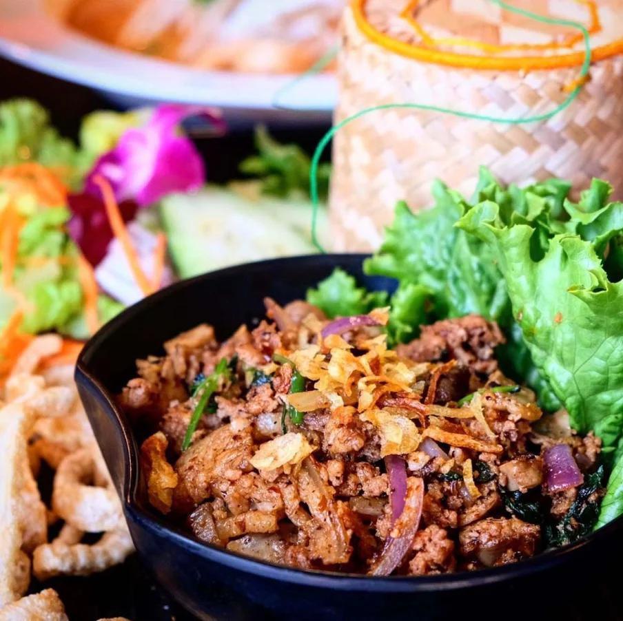 Larb Moo Kua · Northern Thai style ground pork, liver, pork intestine with spicy herb, onions, mint, cilantro and garlic, comes with sticky rice and crispy pork skin.