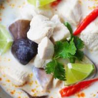 Tom Kha Soup · Coconut milk soup with fresh mushroom, onion, tomatoes, lemongrass, cilantro and lime leaves.