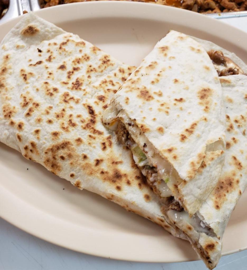 23. Quesadilla Suiza · A big flour tortilla with melted cheese and any meat.