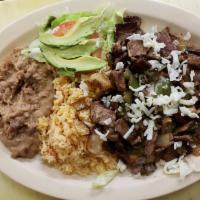 57. Alambre · Chunks of grilled steak, bacon, onion, and bell pepper served with rice, beans, salad, and t...