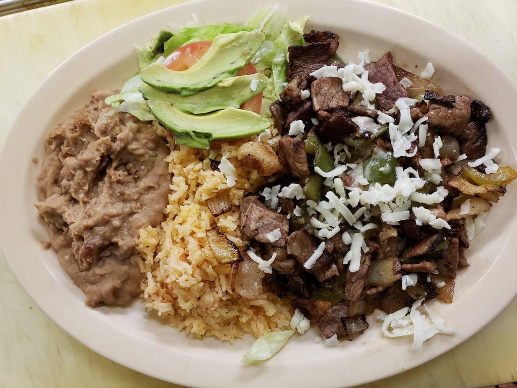 57. Alambre · Chunks of grilled steak, bacon, onion, and bell pepper served with rice, beans, salad, and tortillas.