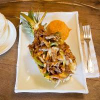 Pina Loka · Grilled pineapple stuffed with chicken, steak, peppers and onions in 
