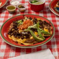 Nachos Deluxe · Choice of: asada, pastor and chicken fajita.served with cheese,  lettuce,  tomato, sour crea...