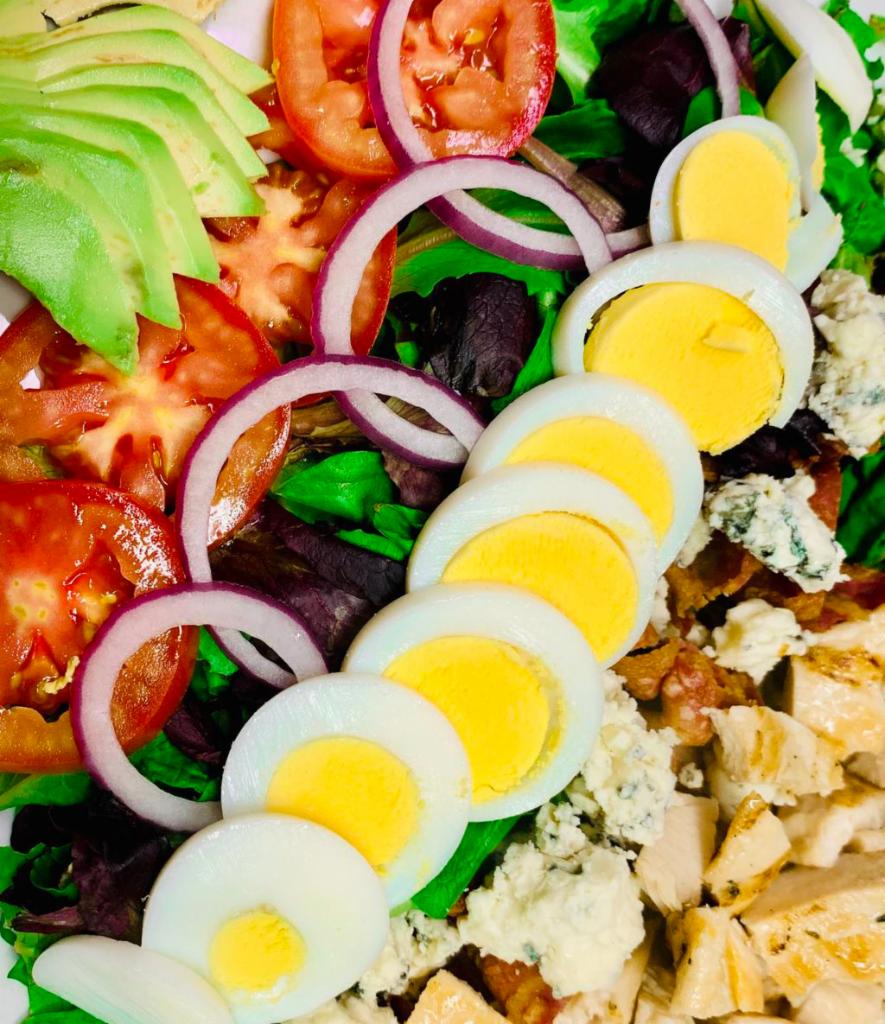 Cobb Salad · Mixed greens, bacon, avocado, blue cheese, onions, tomatoes, hard-boiled eggs and grilled chicken.