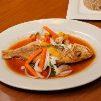 Steamed Red Snapper · Cooked to order. Steamed with vegetables. Served with rice and peas and choice of side.