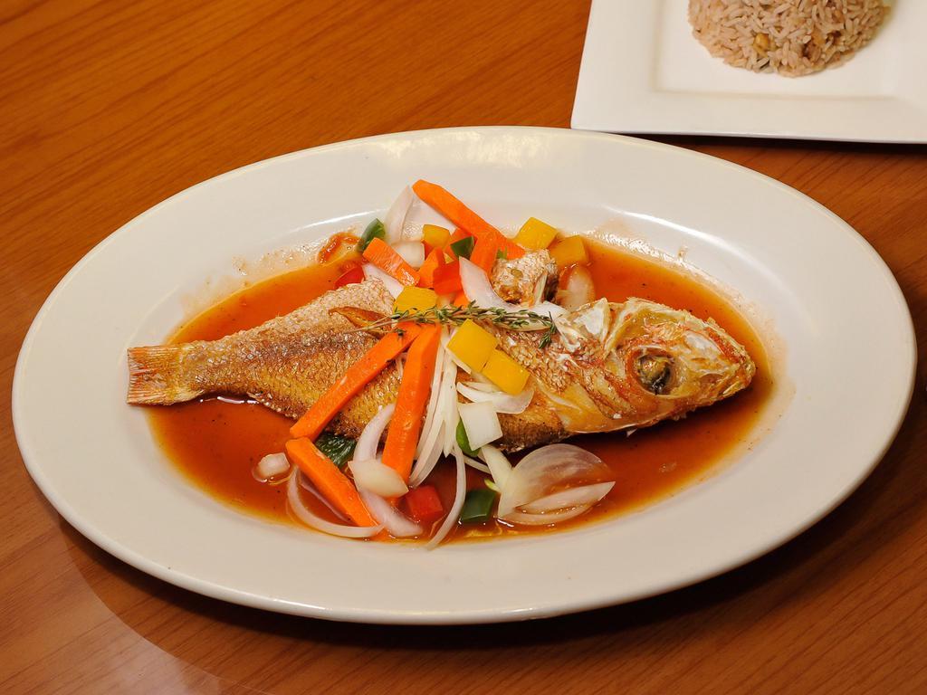 Steamed Red Snapper · Cooked to order. Steamed with vegetables. Served with rice and peas and choice of side.