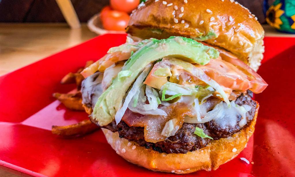 Mexican Burger Plato · Juicy 1/2 lbs. burger with sautéed jalapeños and onions, topped with tomato and avocado. For Mexican style add chipotle mayo and bacon for Hawaiian, add ham and pineapple with Oaxaca cheese. Each served with fries.