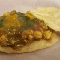 Doubles · A sandwich made with 2 flat fried breads, called bara, filled with channa (chick peas). Topp...