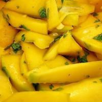 Mango Chow · 1/2 ripened mango seasoned with garlic, herbs and hot peppers.