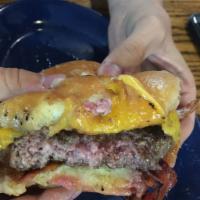 1/2 lb. Fresh Angus Burger with 2 Sides · Angus beef burger.