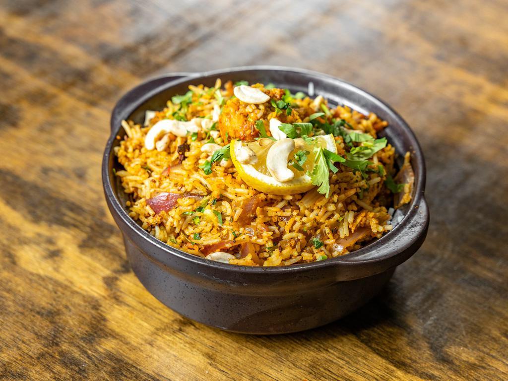 Chicken Biryani · Indian basmati rice flavored with saffron, cooked mughlai style with boneless chicken, nuts, spices and herbs. 