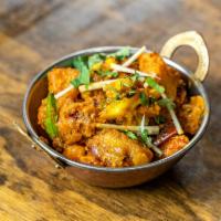 Aloo Gobi · Fresh cauliflower and potatoes cooked with curry sauce, fresh tomatoes and spices. Served wi...