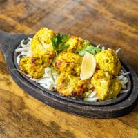 Garlic Tikka · White chicken marinated in garlic, freshly ground spices and lemon juice, roasted in our tan...