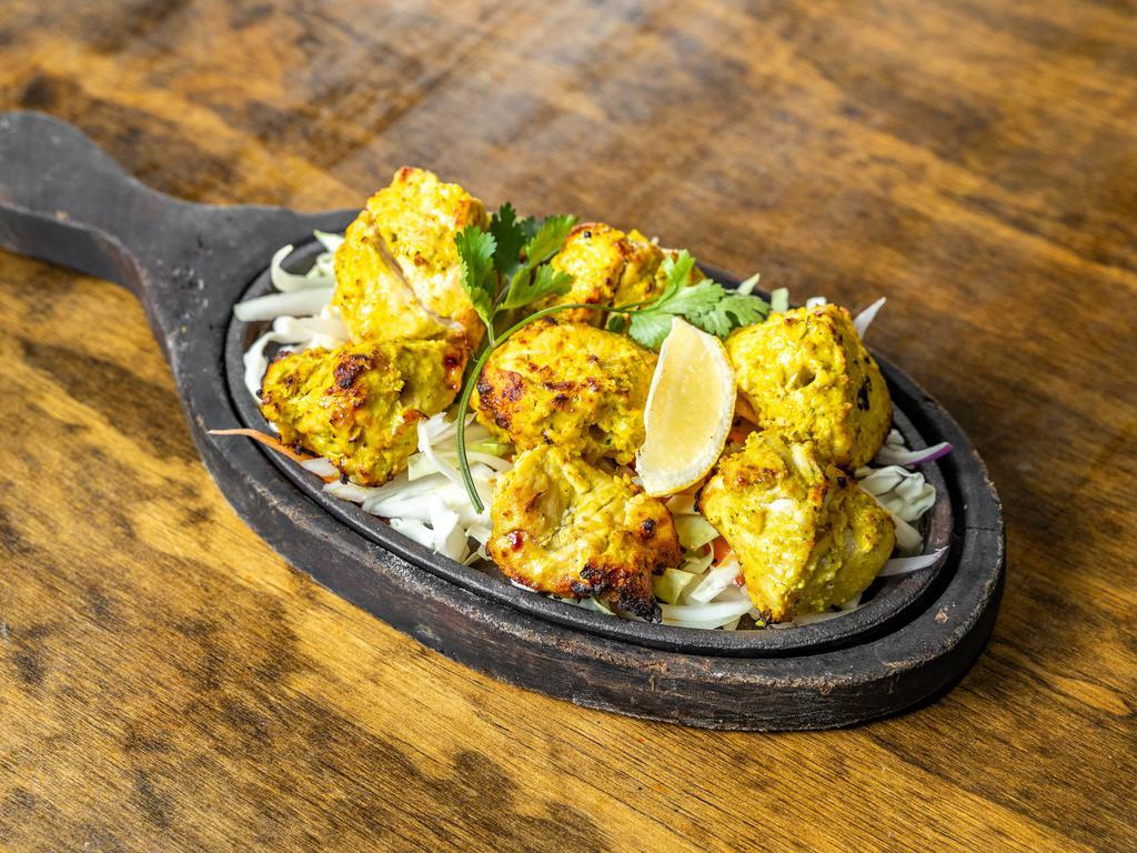 Garlic Tikka · White chicken marinated in garlic, freshly ground spices and lemon juice, roasted in our tandoori clay oven.