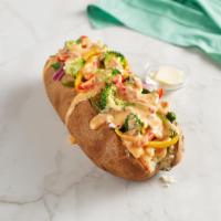 Veggie Spud · With spinach, broccoli, red onions, house roasted multicolored peppers, and RO*TEL cheese sa...
