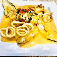 Pescado a lo macho · Fish fillet with octopus, squid, mussels, red bell pepper, topped with a creamy sauce, serve...