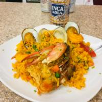 Arroz con Mariscos · Peruvian paella with shrimp, octopus, squid, mussels and yellow rice.