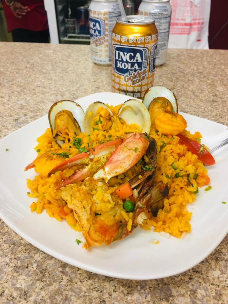 Arroz con Mariscos · Peruvian paella with shrimp, octopus, squid, mussels and yellow rice.