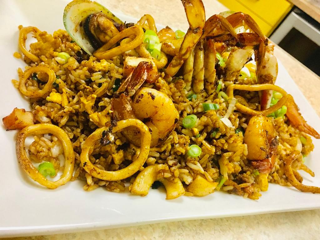Arroz Chaufa de Mariscos · Shrimp, octopus, squid and mussels with brown  fried rice.