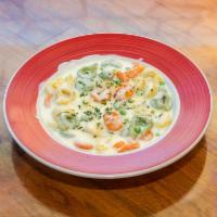 Tri-Color Tortellini Pasta · Tortellini pasta stuffed with spinach, peas, and Parmesan cheese in Alfredo sauce.