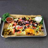 Pulled Pork Nachos · Corn tortilla chips loaded with jack and cheddar cheese and BBQ marinated pulled pork. Toppe...