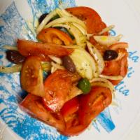 Insalata di Pomodori · Tomatoes, onions, black olives, extra virgin olive oil and oregano.