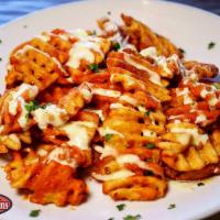 Buffalo Fries · Waffle Fries Tossed in a Buffalo Sauce, Drizzled w/ Blue Cheese Dressing