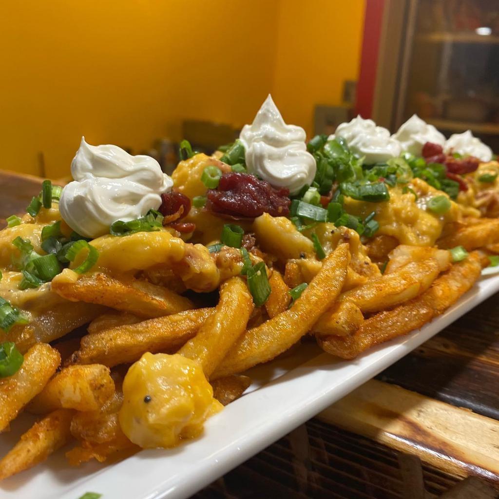 Dorian's Hi-Jacked Fries · Seasoned fries, topped with our bacon cheddar potatoes, sour cream, crispy apple wood bacon and green onions. Think loaded potato skins hi-jacked.