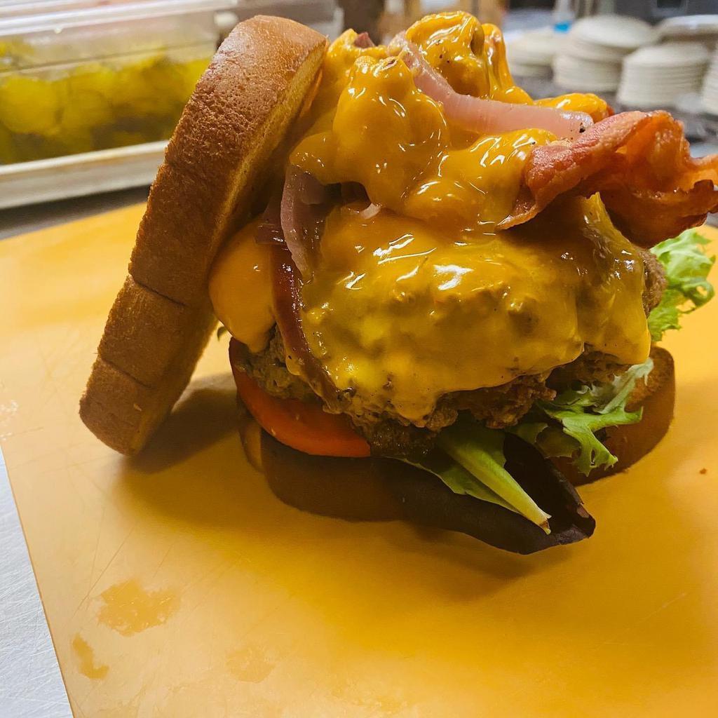Big Mouth Burger · 1/2 lb. seasoned ground beef, lettuce, pickle, bacon, cheddar cheese, sauteed red onion, and special sauce and bun.