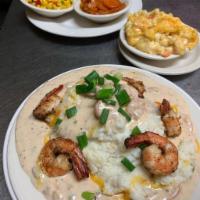 Kiss My Grits · Old fashioned cheese grits atop our seafood cream sauce and succulent sauteed shrimp. Spicy.