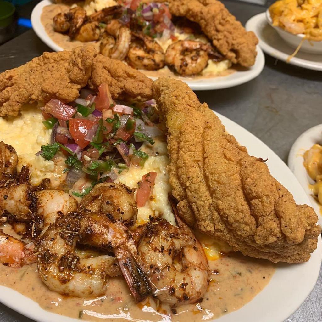 New Orleans Catfish Shrimp and Grits · Fried catfish served atop cheese grits topped in our seafood cream with New Orleans styled shrimp.