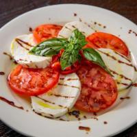Buffalo Caprese Salad · Tomatoes, Buffalo mozzarella, basil, and extra virgin olive oil.