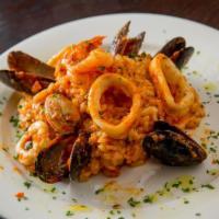 Risotto Pescatore · Mussels, shrimp, calamari and clams sauteed with garlic and white wine.
