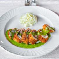 Rollatino di Pollo · Lightly breaded and baked chicken stuffed with prosciutto, provolone and zucchini over a lig...