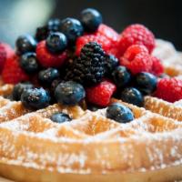 Breakfast Belgian Waffle · Dusted with powdered sugar and topped with fresh fruit, served with maple syrup.