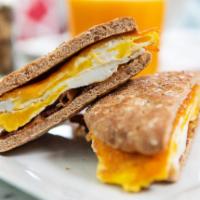 Breakfast Sandwich · 2 scrambled eggs on a toasted multigrain roll or croissant with your choice of ham or bacon,...